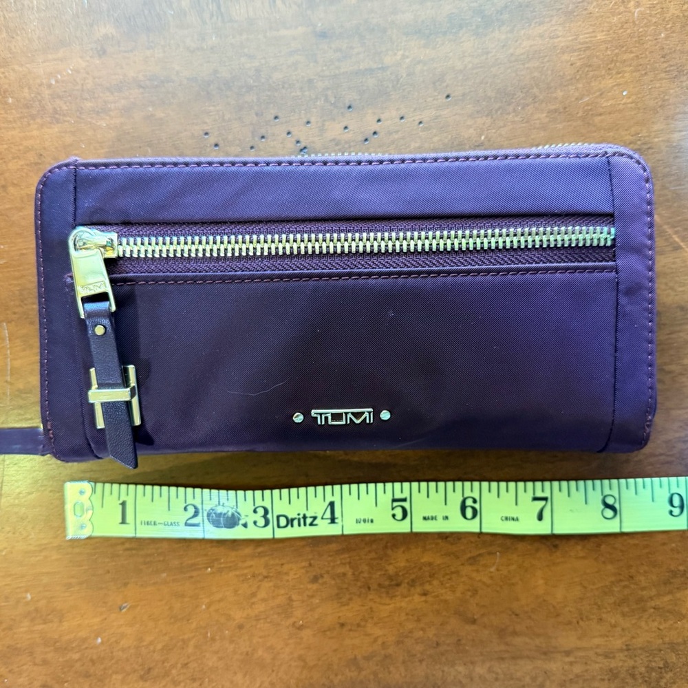 Tumi Maroon Wallet with Gold Zipper and Leather Accents